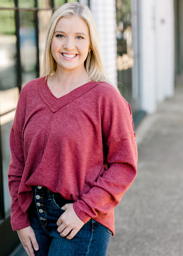 Blonde model wearing mauve sweater.