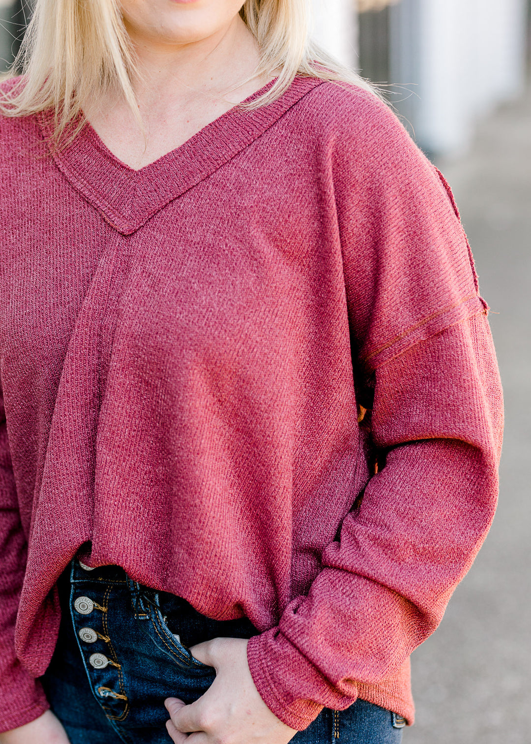  Close up view of Blonde model wearing mauve sweater.