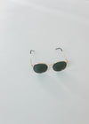 Round framed gold rim sunglasses.