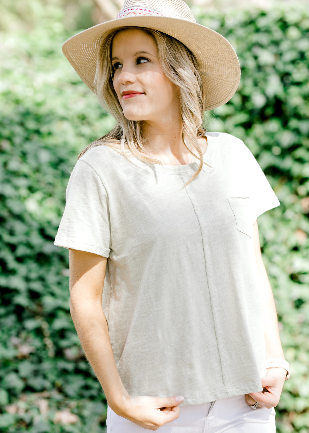 Straw hat with aztec band in cream, red, and green on blonde model wearing tee shirt.