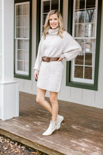 Blonde model wearing ivory sweater dress.