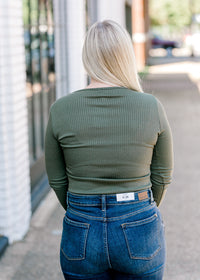 Back view of Blonde model wearing olive bodysuit.