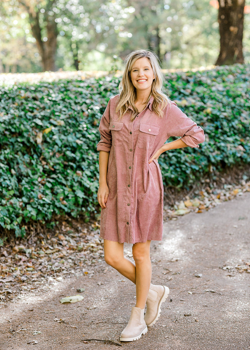 Blonde model wearing purple button up corduroy dress with booties.