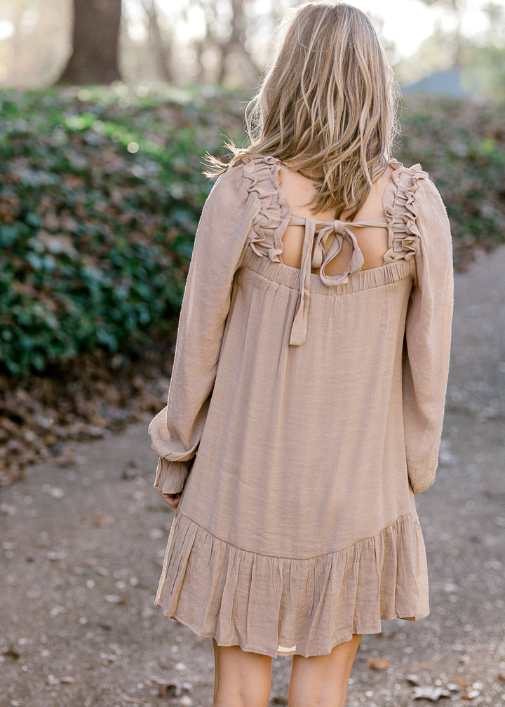 Back view of tie on Blonde model wearing sand colored. 