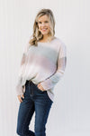 Blonde model wearing an ombré long sleeve sweater. 