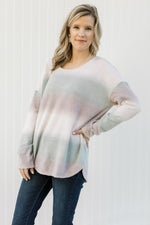 Blonde model wearing an ombré long sleeve sweater with a round neckline. 