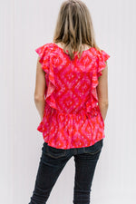 Back view of Blonde model wearing a bright pink top with capped sleeves.