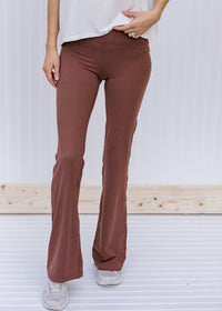 Front view of Blonde model wearing brownish flared yoga pants.