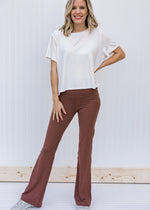 Blonde model wearing brownish flared yoga pants.