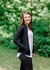 Brunette model wearing front zip athleisure jacket.