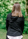 Back view of Brunette model wearing front zip athleisure jacket.