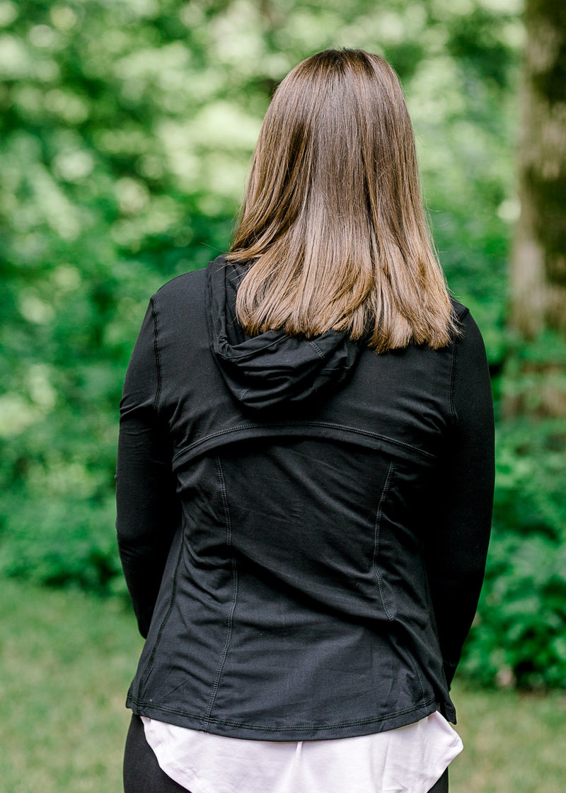 Back view of Brunette model wearing front zip athleisure jacket.