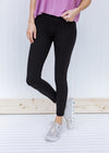 Model wearing full length black leggings.