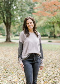 Brunette model wearing ash and charcoal two toned top.