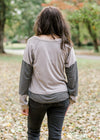 Back view of Brunette model wearing ash and charcoal two toned top.