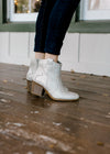 Model wearing natural shimmer bootie.