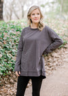 Blonde model wearing charcoal top with leggings.