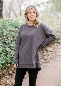 Blonde model wearing charcoal top with leggings.