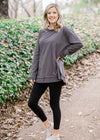 Blonde model wearing charcoal top.