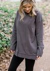 Blonde model wearing charcoal long sleeve top.