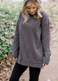 Blonde model wearing charcoal long sleeve top.