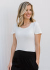 Blonde model wearing white tee shirt bodysuit.